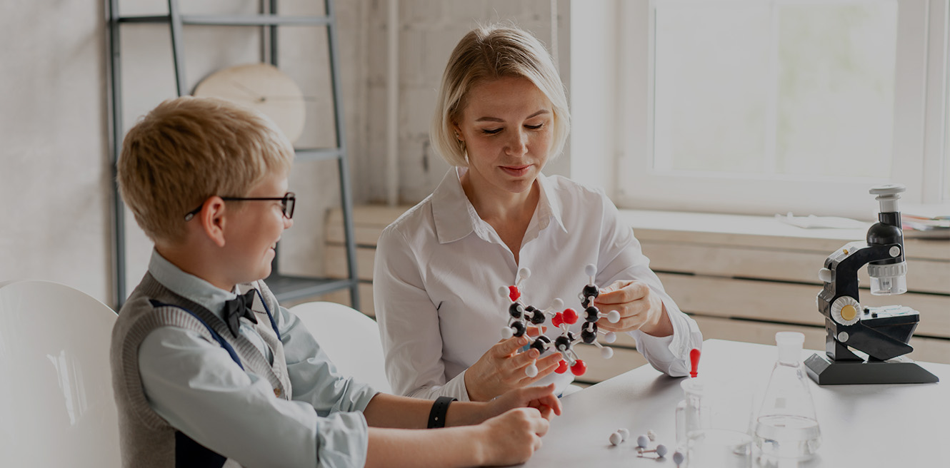 Female science tutor in Huntington studying chemistry with student