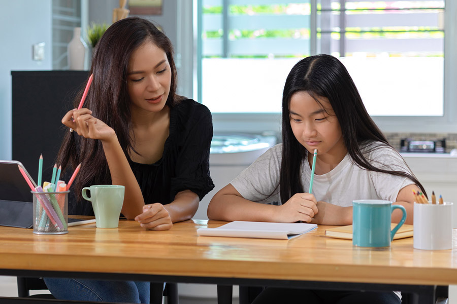 student and tutor together at a desk in Huntington